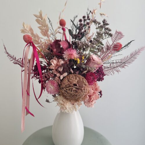 Pink dried arrangement in ceramic vase